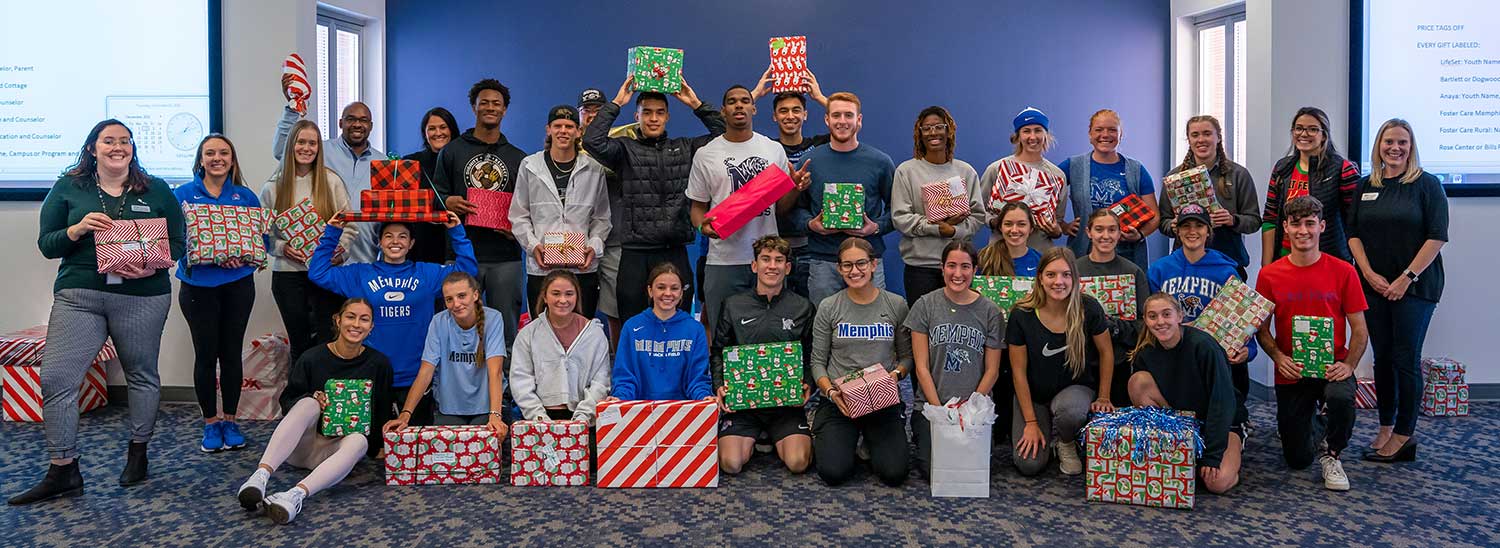 UofM_Holiday_Heroes_Wrappping_26 University of Memphis Athletics department with wrapped presents