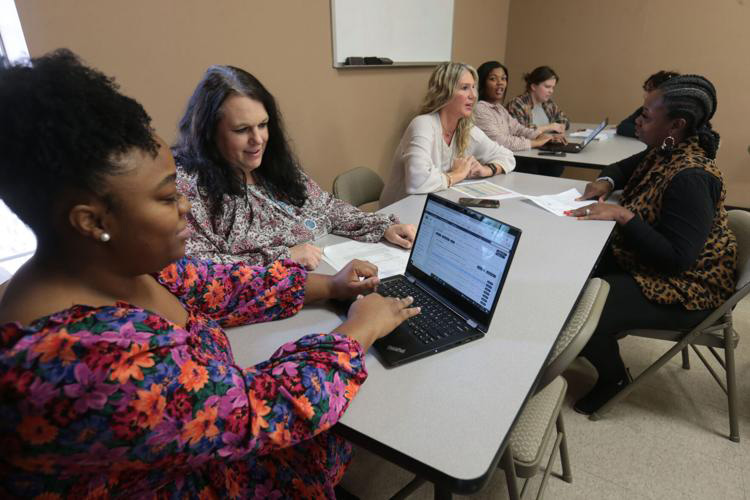 Tupelo-Mississippi-Youth-Villages-Staff-meeting Youth Villages staff talking at a meeting