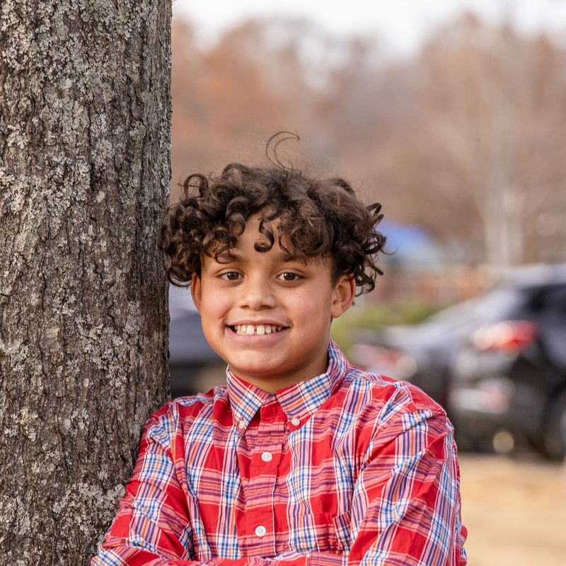 Elijah_03 Elijah standing next to a tree smiling