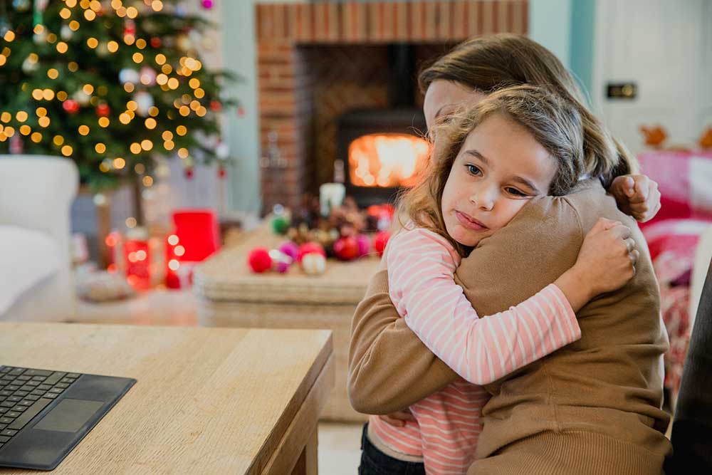 sad-girl-at-christmas sad young girl at Christmas hugging her mother