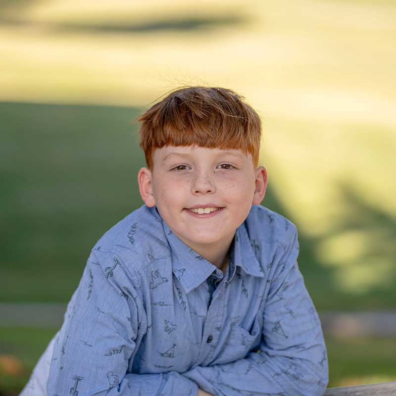 Gabe-2 portrait of Gabe standing behind a bench