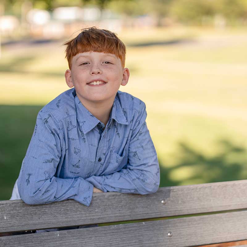 Gabe-3 portrait of Gabe standing behind a bench