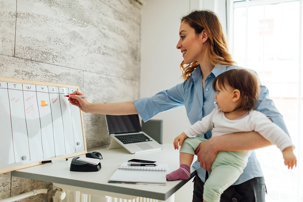 Caregiver burnout mother carrying child while working