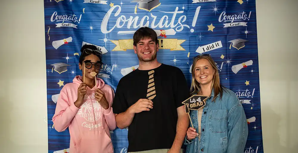 Idendependent_Living_Oregon_Savannah_Ethan_Emma ILP Specialist Savannah; ILP graduate and newest Youth Villages Oregon employee, Ethan; and Ethan’s former specialist and current Hiring Coordinator, Emma at a graduation party