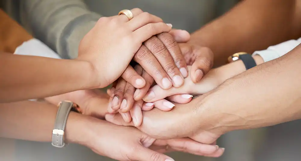 hands stacked together photo of hands stacked on top of each other