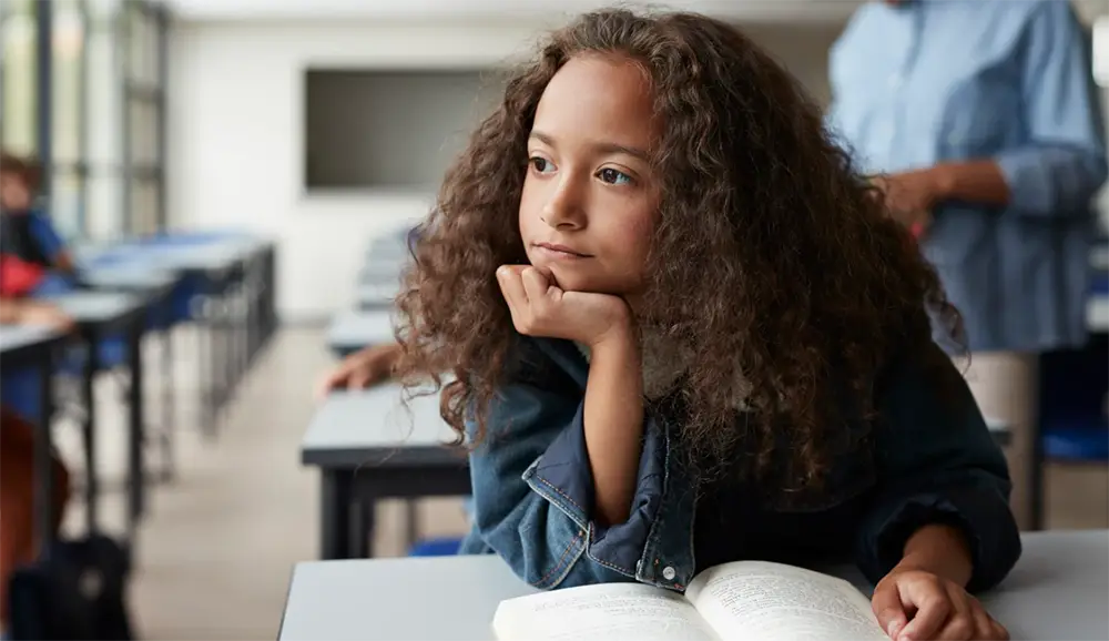 7 things elementary-age kids-worry-about young child in classroom with book