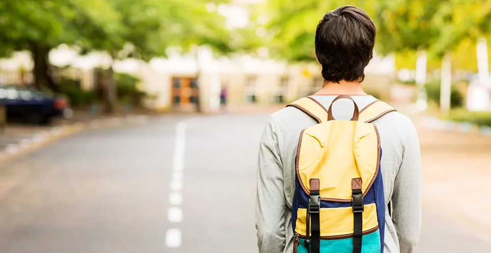 YV25-Mike-Intercept-NC young man walking with backpack